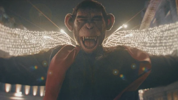 Ape that: Robbie Williams monkeys about in biopic